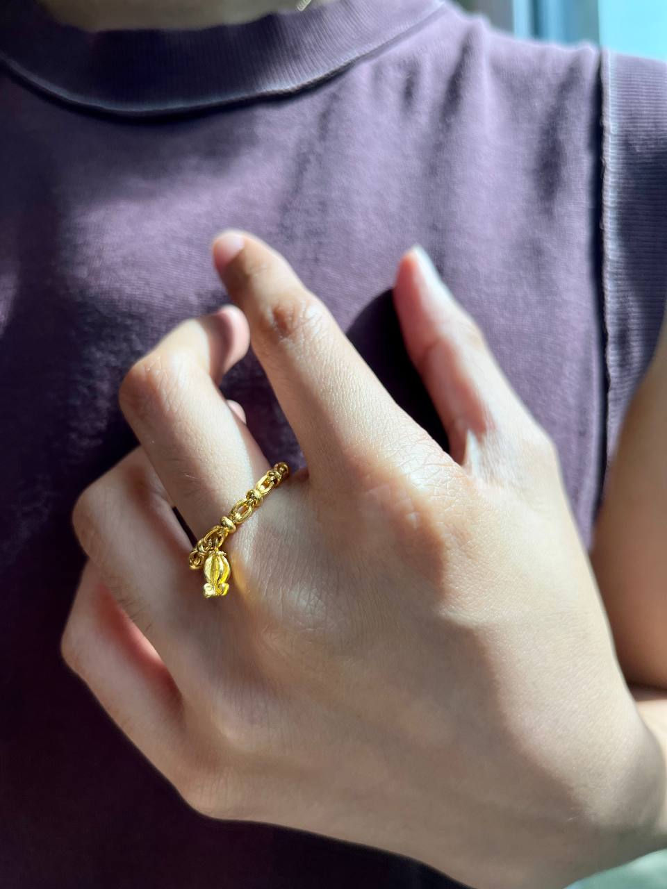 Close-up view of a minimalist gold ring on a white background