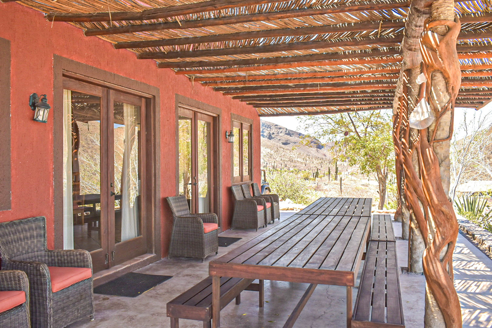 long rustic wood dining table on outdoor terrace