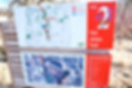 powder-coated graphics on aluminum map sign in red and white on forest trail 