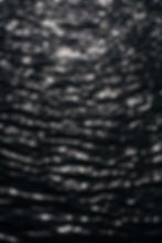 lineal patterns provided by sunrays which are scattered across a body of water.
