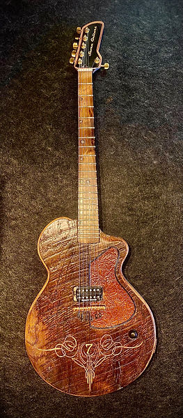 Handcrafted custom guitars made from reclaimed historic materials displayed in the workshop.