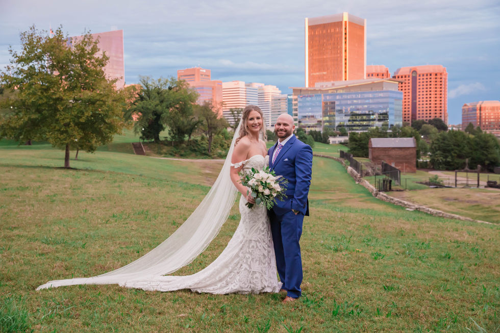 Lauren Kent Photography - Bride and Groom Portrait of Richmond, Virginia skyline at sunset - Virginia War Memorial