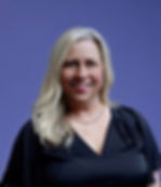 Ms. Rhonda smiling in a black top.