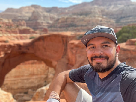 Career & Professional Development Coach, Robert Harjo on a hike among sandstone cliffs and plateaus.