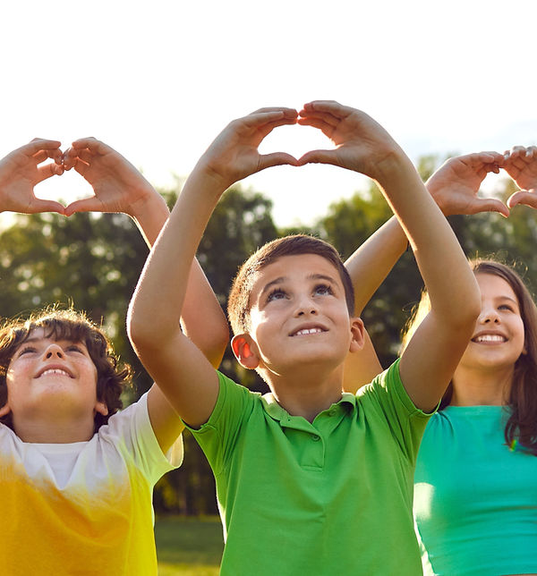 Children raising heart-shaped hands, celebrating the joy, inspired by the generosity of Pay It Forward Sponsors.