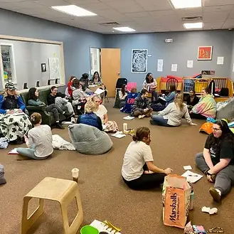 A group of individuals participating in a group wellness class in Connecticut, engaging in community building and wellness