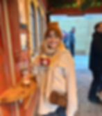 Girl in a hat holding mulled wine at a Christmas market in Cologne, Germany