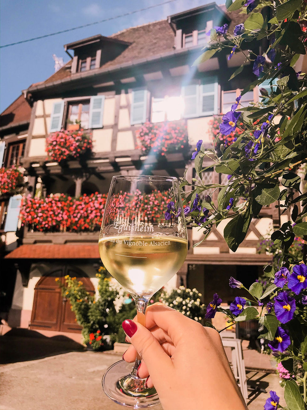 Glass of wine outside a winery in Eguisheim, the Alsace region of France