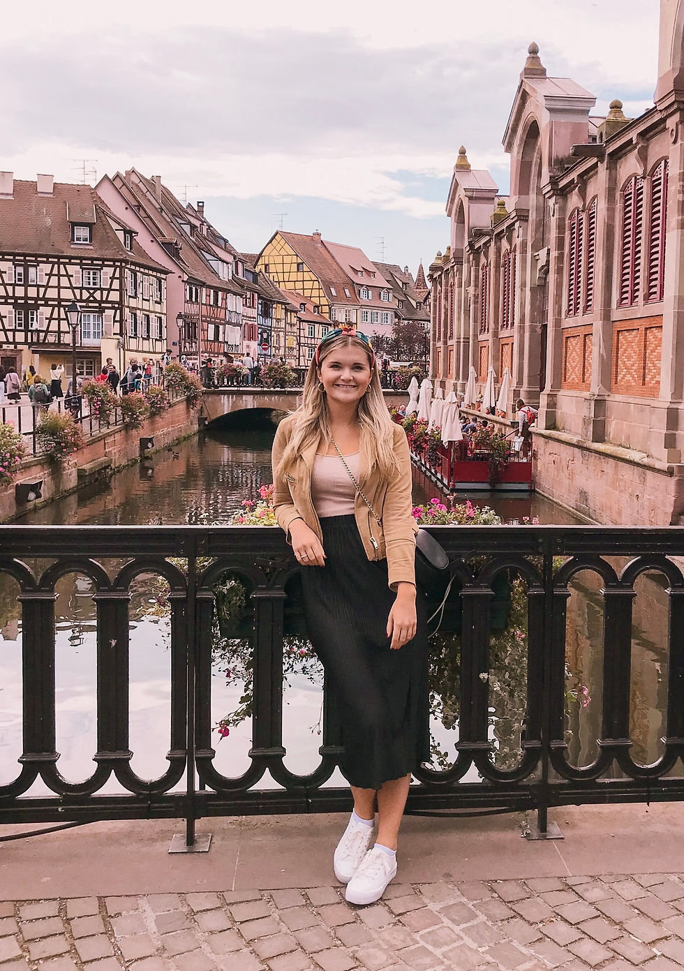 Girl standing on a bridge with a view in Colmar, the Alsace region of France