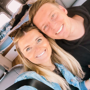 Couple driving in a converted camper van in Banff, Alberta, Canada