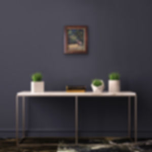 deer pastel painting framed on dark wall over table