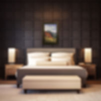 landscape painting framed on paneled wall above bed