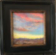 colorful desert sunset painting in dark wood frame
