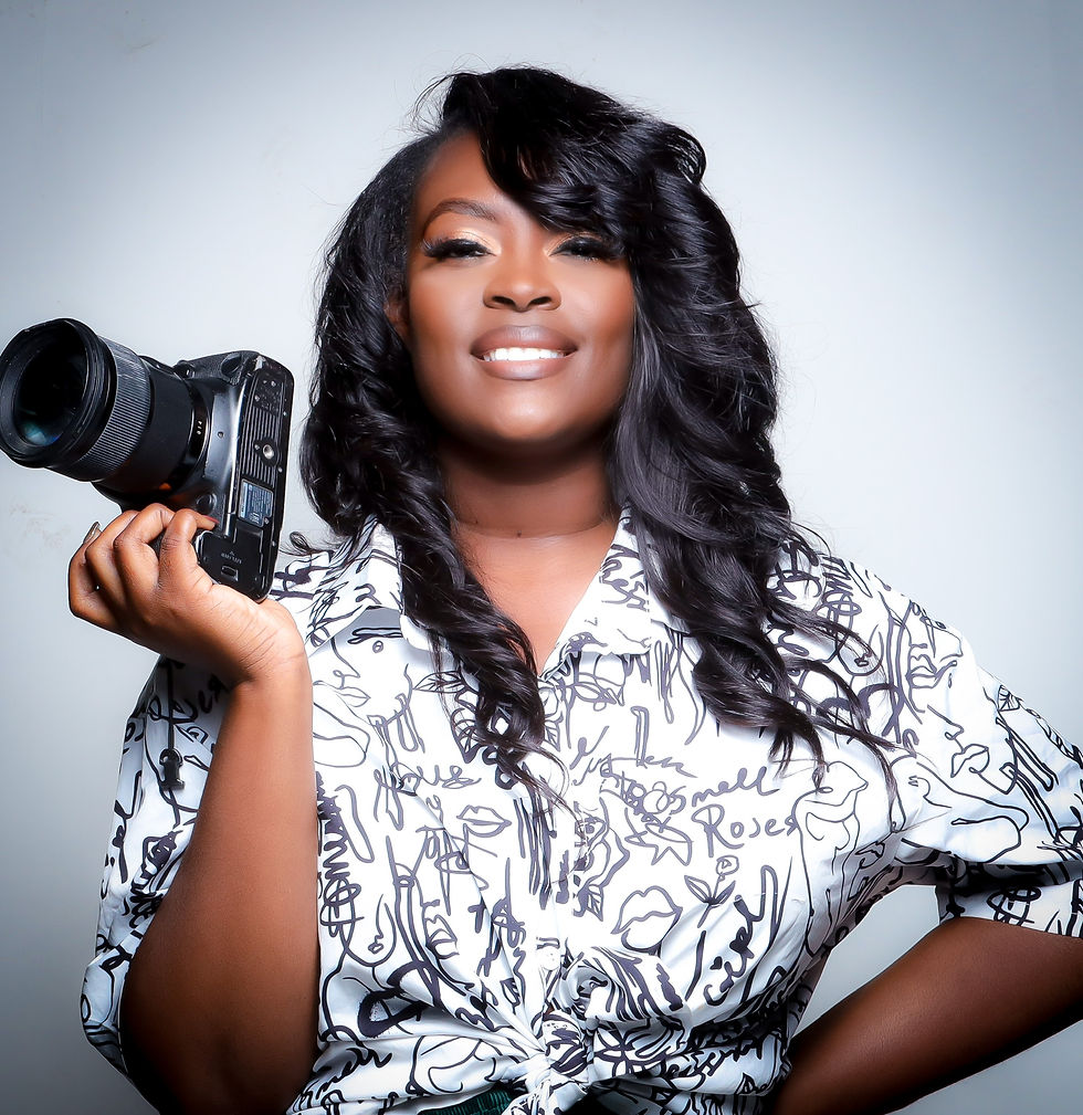 black woman photographer holding camera, ready to capture moments