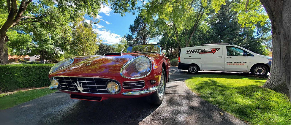 Home page banner featuring a red vintage Maserati being detailed by On The Spot Detailing, with their branded truck in the background, set against the scenic backdrop of Albuquerque, New Mexico, highlighting their mobile detailing expertise