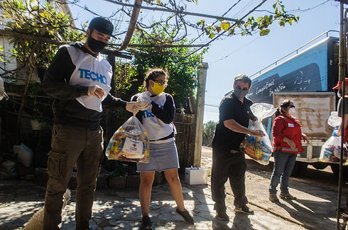 A human chain carries emergency bags