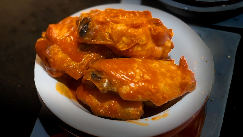 Plate of saucy Buffalo wings from Port Bistro & Pub in Smithtown, a top Long Island Super Bowl wing spot.
