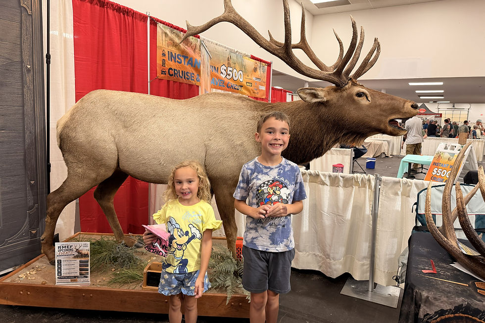 Visitors posing with the full-body bull elk display at the Richmond show.