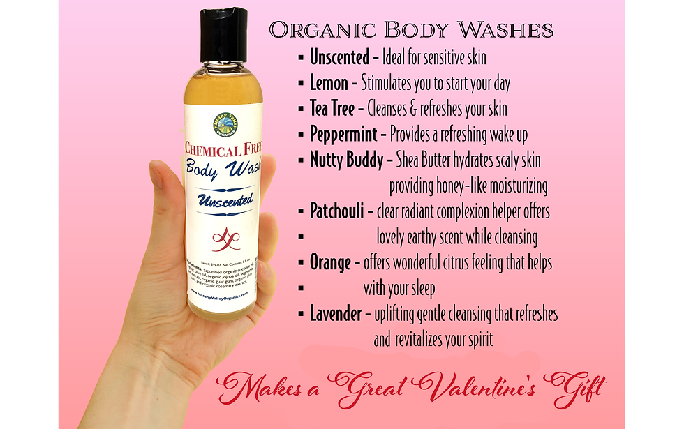 Eye-level view of glass bottles with organic oils and herbs on wooden table