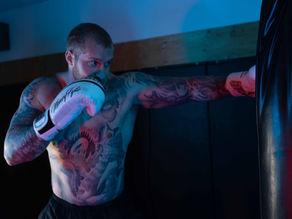 Man training boxing and strength as part of mental resilience and discipline-focused fitness program