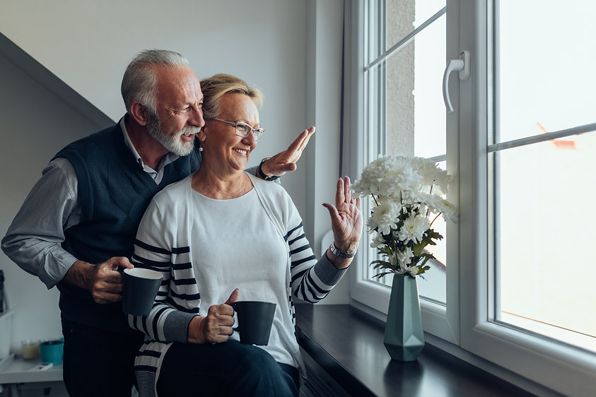 Man and woman waving out window