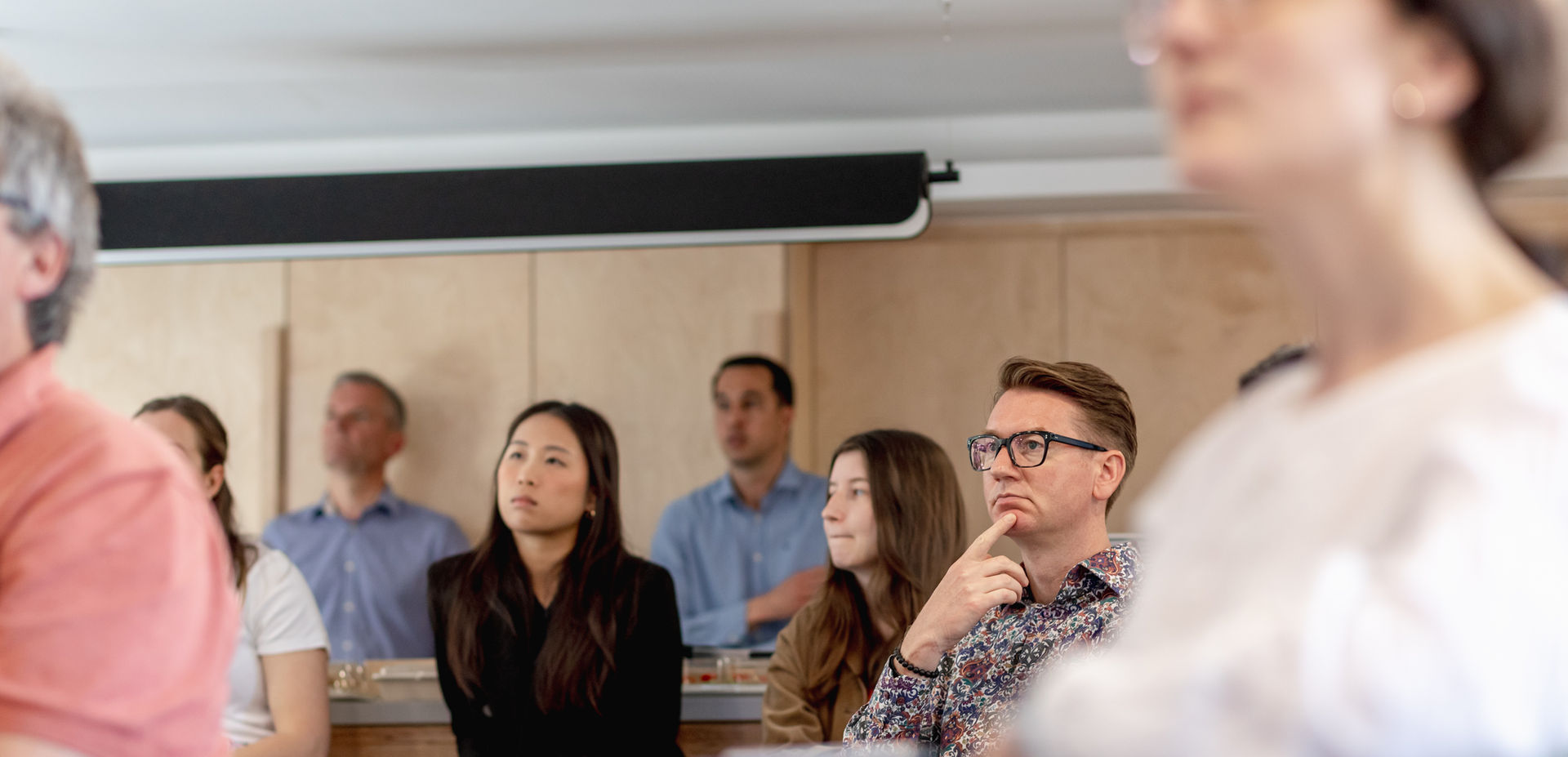 Group of people listening intently at a meeting