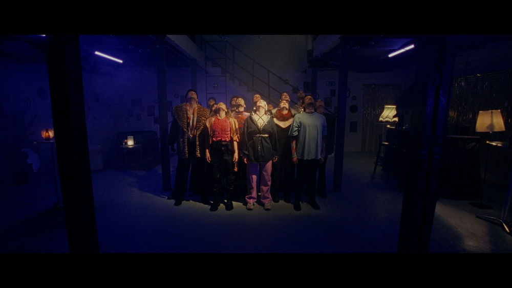 Group of people in a dark room with blue light