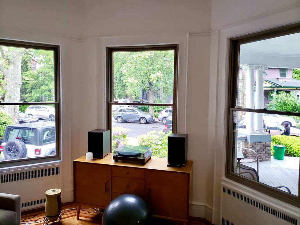 Room with large windows and audio equipment.