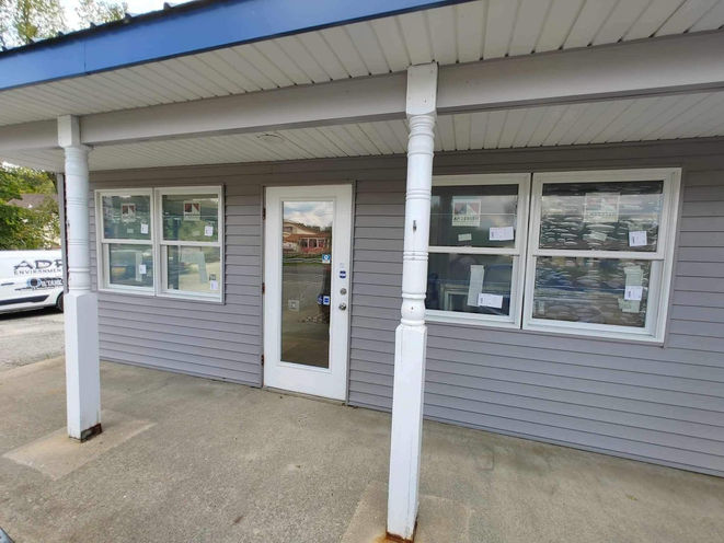 Small building with a glass door and windows.