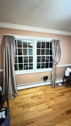 Room with large window and shiny curtains.