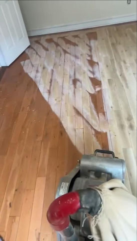 Floor being sanded with a machine.