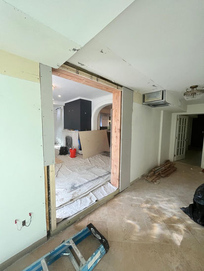 Room under renovation with exposed wall and tools.