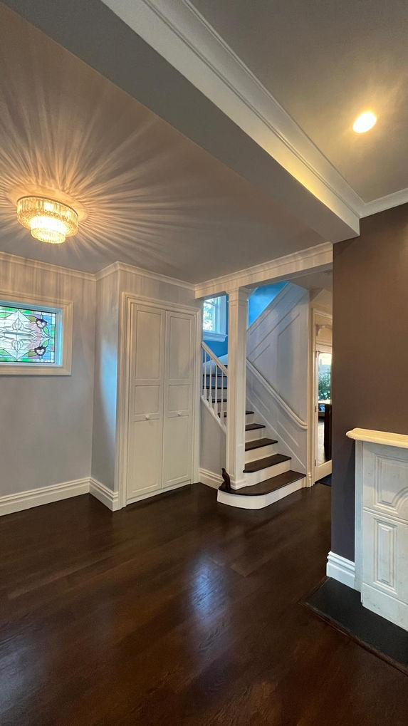 Elegant interior with staircase and decorative lighting.
