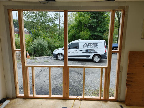 Van outside window frame under construction.