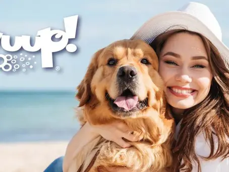 A happy lady hugging her dog
