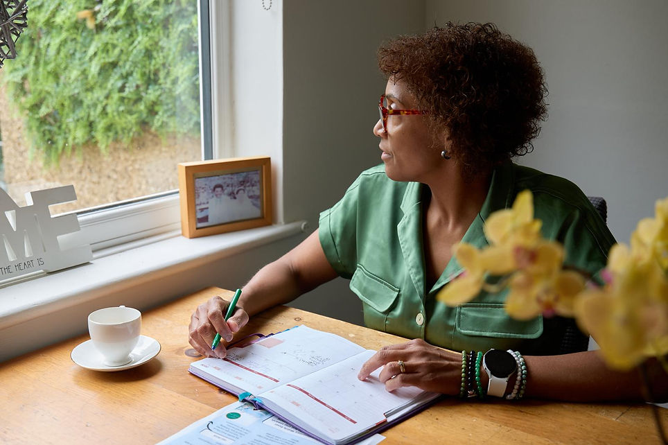 Roxanne writing at her desk and reflecting on health and wellbeing