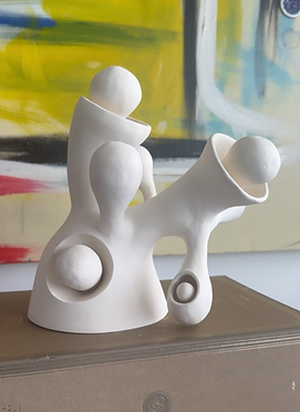 Contemporary white ceramic sculpture inspired by the universe and black holes.