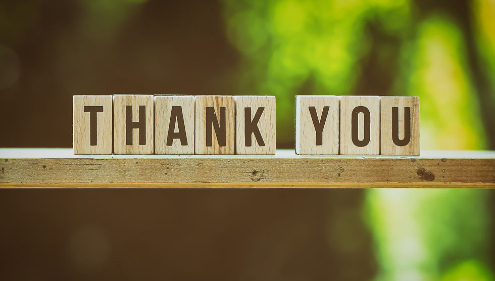 Wooden blocks spell out "Thank You"