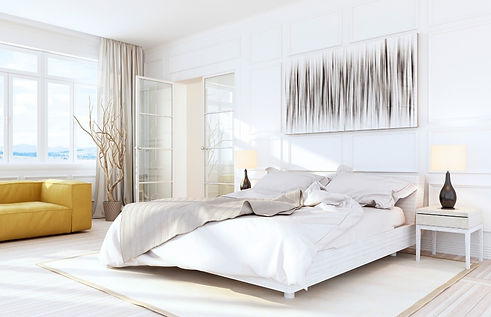 All white contemporary bedroom with glass french doors and a wainscoting accented wall