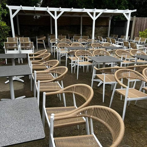 Outdoor café seating area with tables and chairs in garden space Cambridge