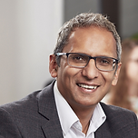 Yogesh Chauhan, head shot, indian man with glasses, white button up and black blazer