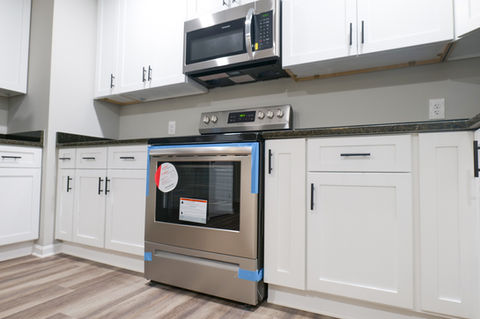 stainless steel stove and white cabinets
