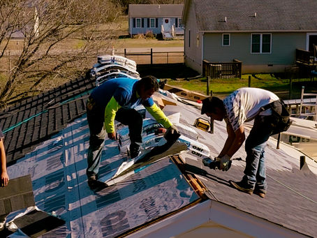 men removing roof shingles