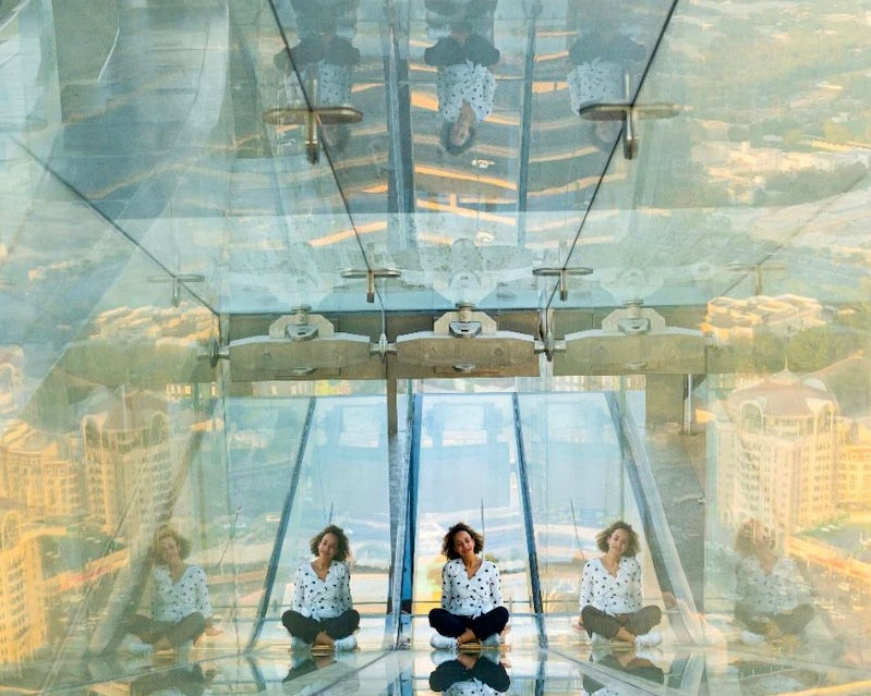 Woman sitting on floor with reflections, The Lounge, Burj Khalifa, Dubai DOO