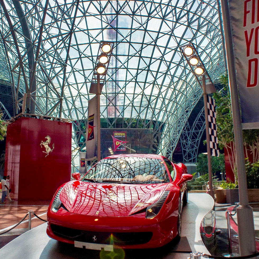 Red Ferrari car display FIND YOUR DREAMS banner advertisement DUBAI DOO