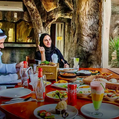 Family dining at a restaurant with food and drinks in DUBAI DOO.