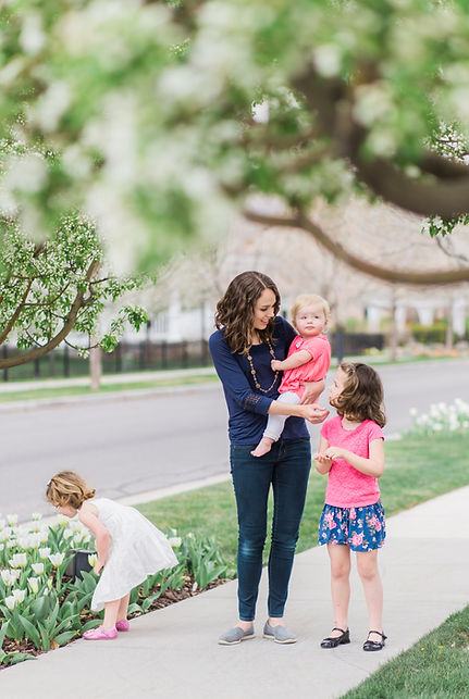 mom and young daughters out for a spring walk in Salt Lake City, utah