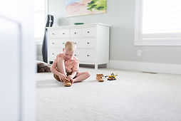 preschool boy putting on his shoes in the master bedroom of their Salt Lake City, Utah home