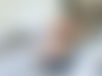 mom and her preschool son cuddle together on the living room sofa of their South Jordan, Utah home