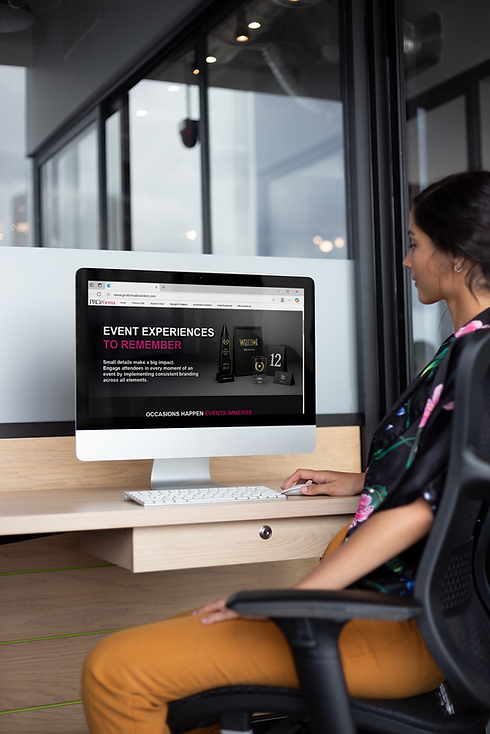 woman-working-on-an-imac-mockup-on-a-wooden-desk-a21170.png